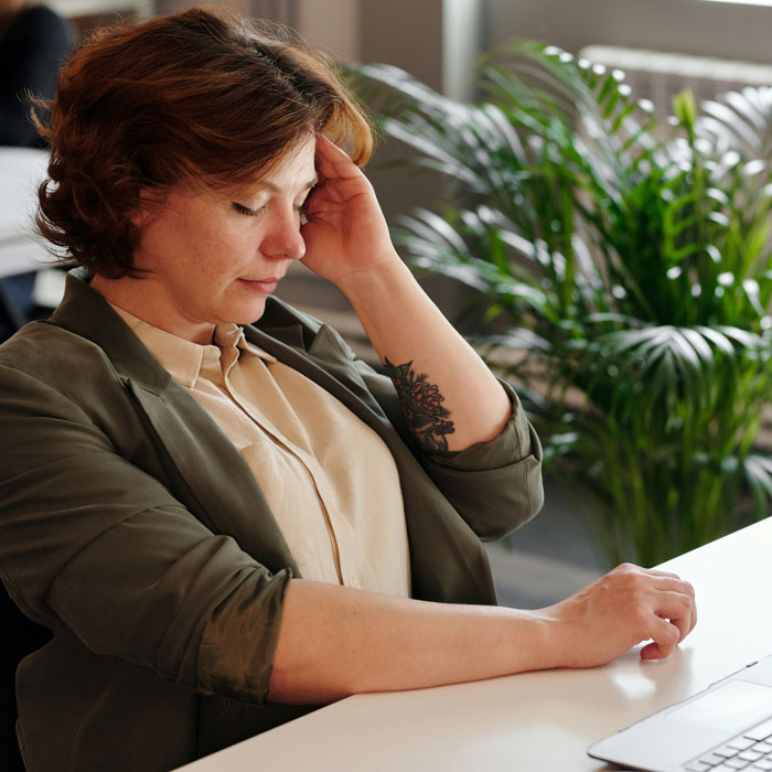 Tired woman at office II